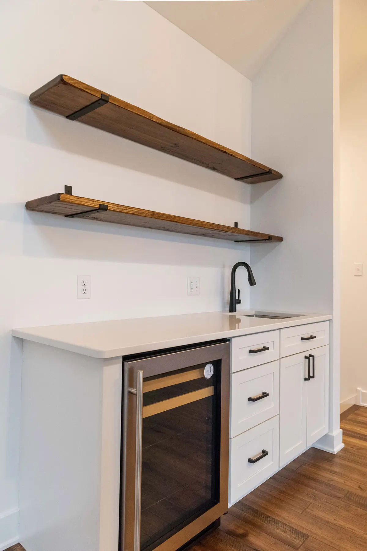 Bar with floating shelves and beverage cooler