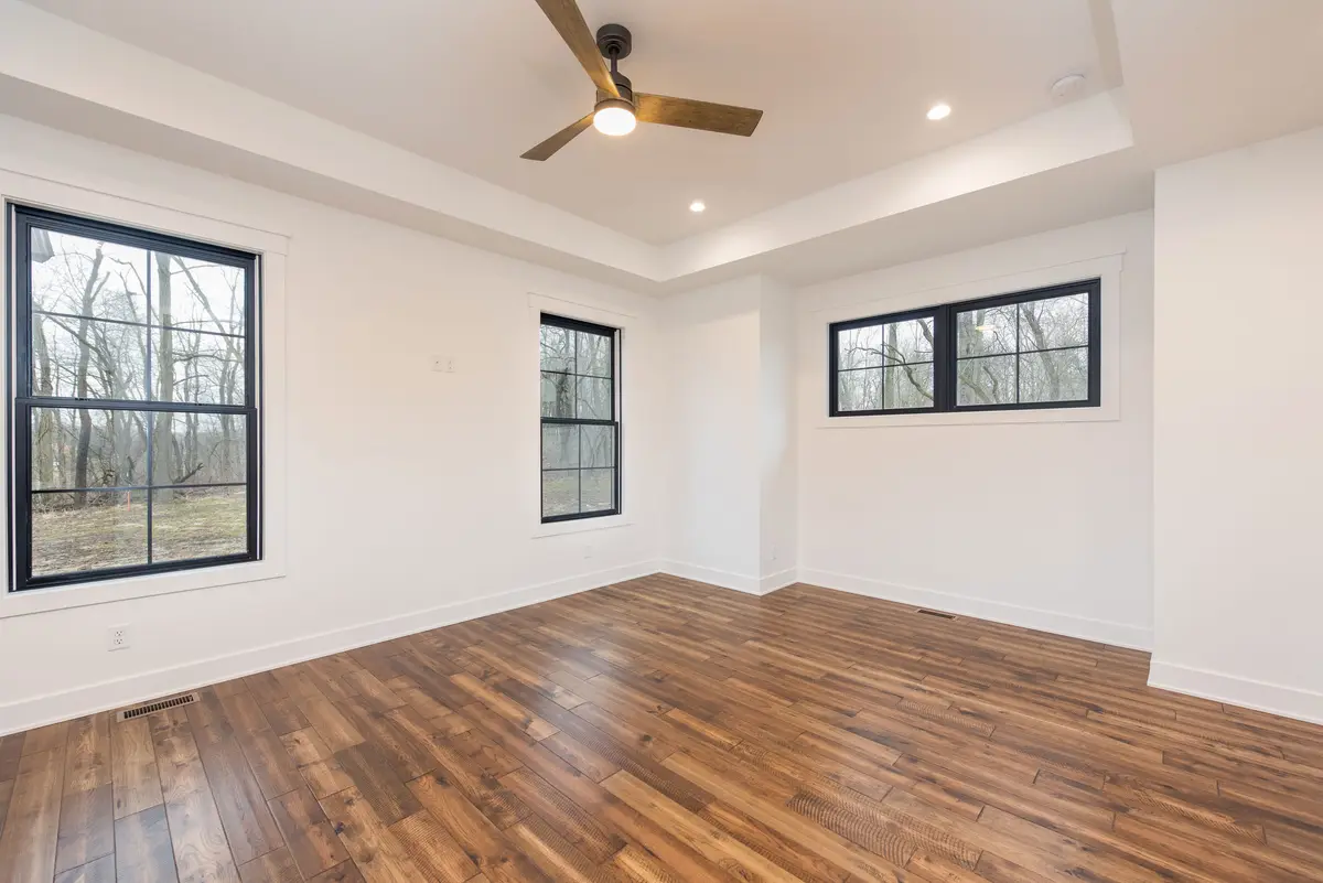 Living room with hardwood floors and tray ceiling