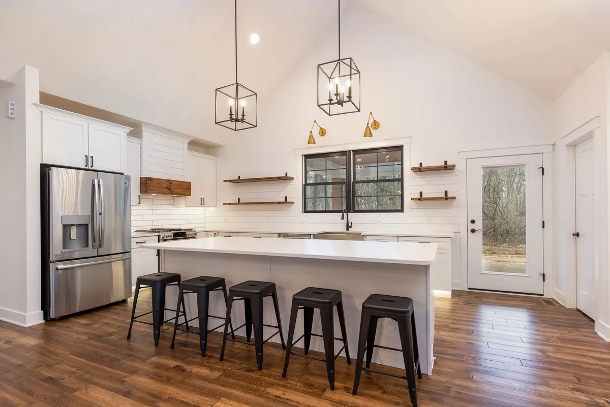 White kitchen with island and pendant lights