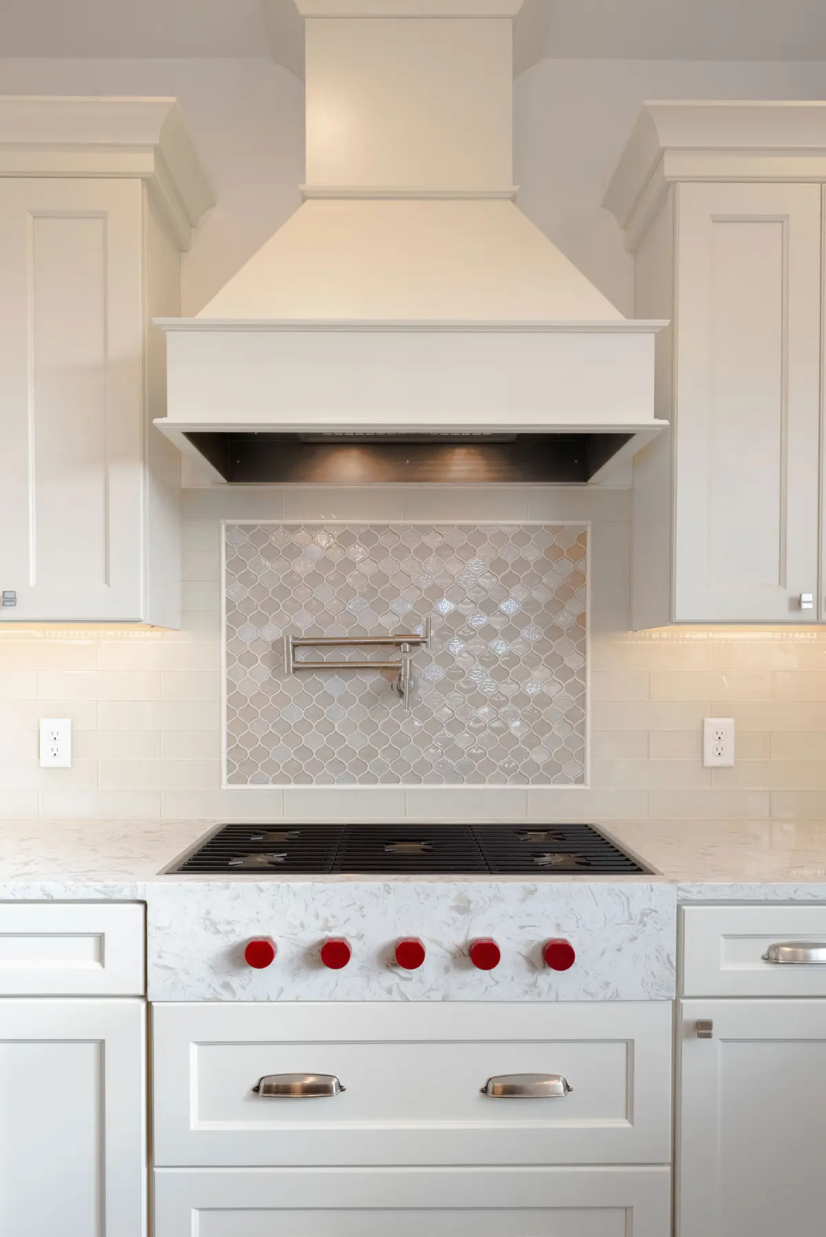 Custom range hood with stacked tile backsplash
