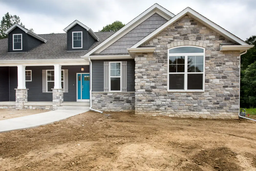 White craftsman with stone columns
