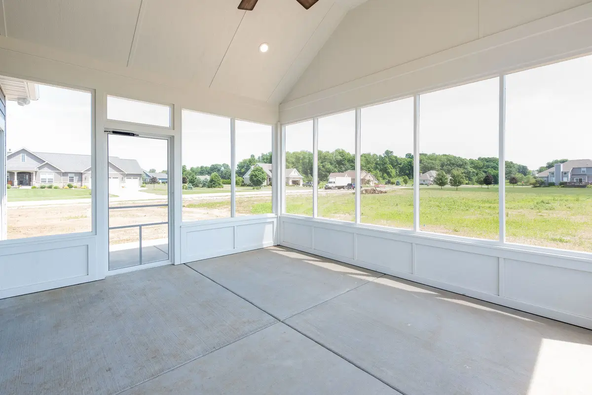 Open great room with stone fireplace and picture window