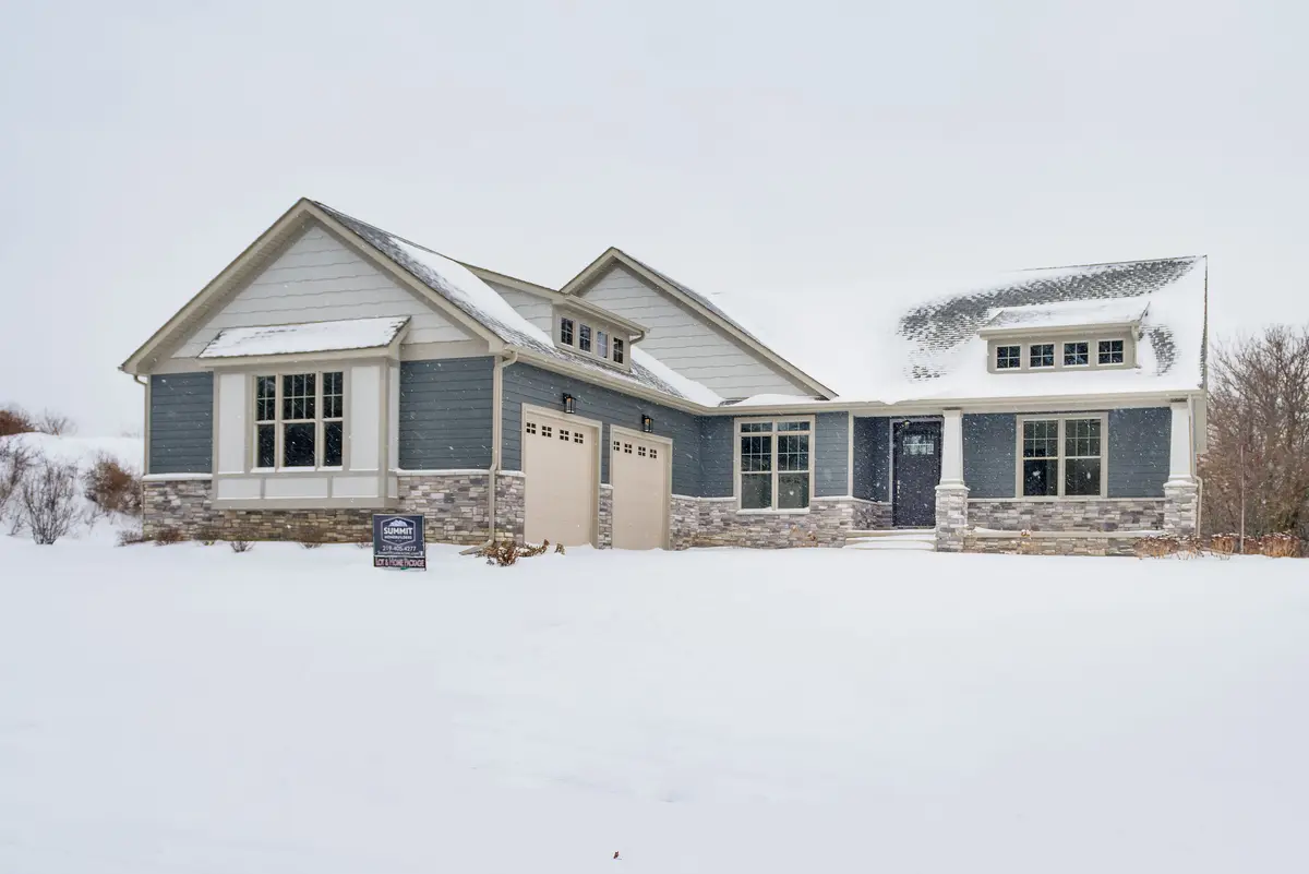 Blue craftsman home in winter