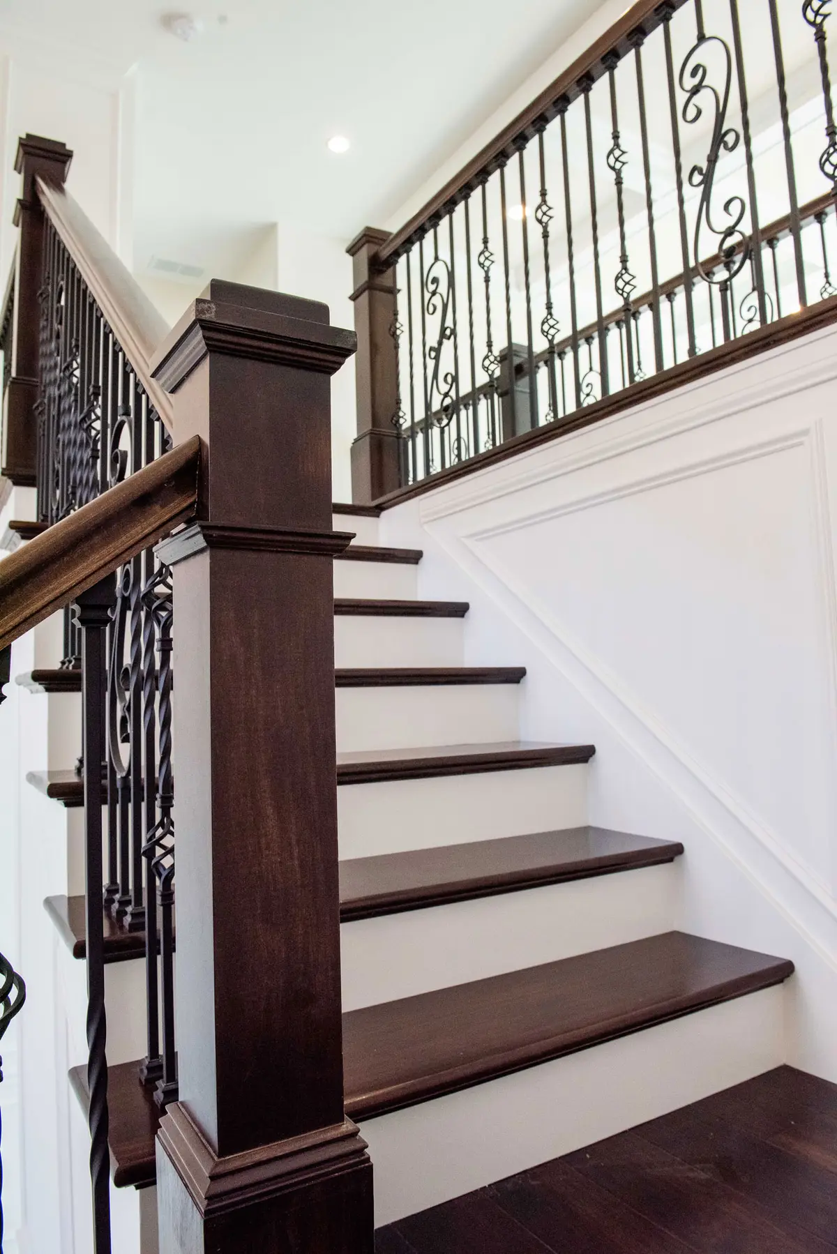 Stairwell with iron balusters and wood treads
