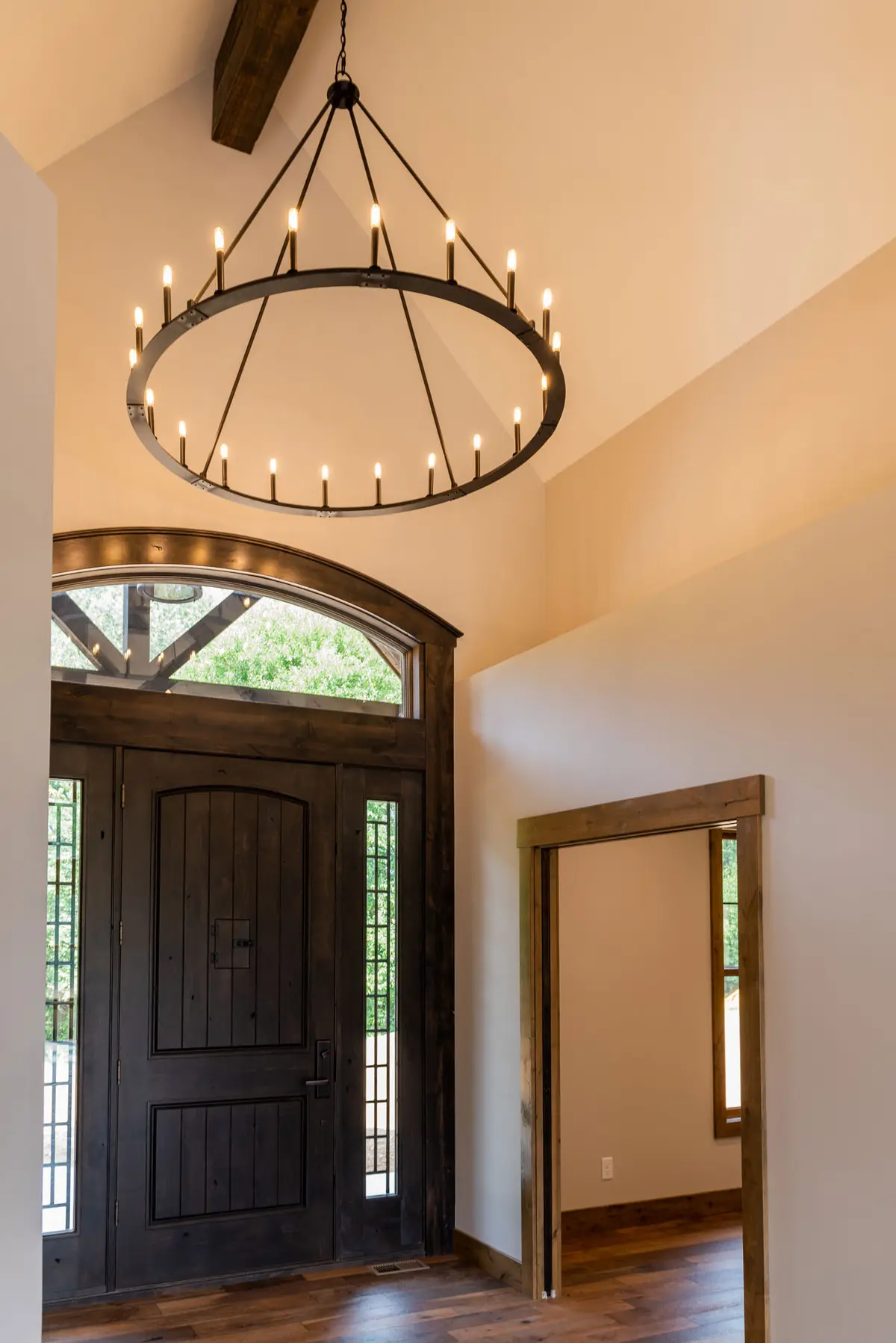 Foyer with chandelier and arched front door