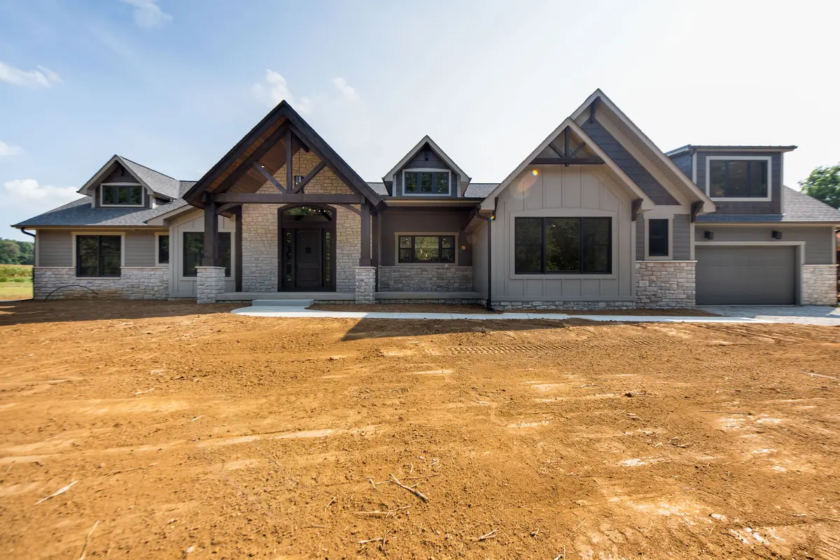 Stone-and-siding craftsman with three-car garage