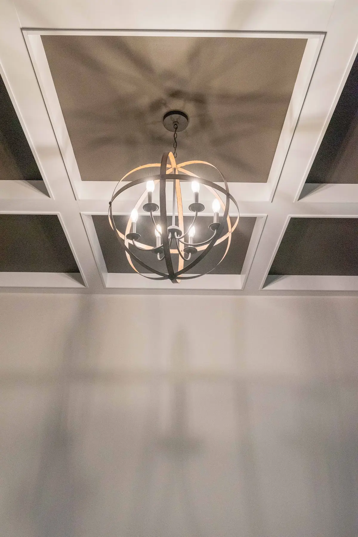 Iron chandelier with coffered ceiling detail