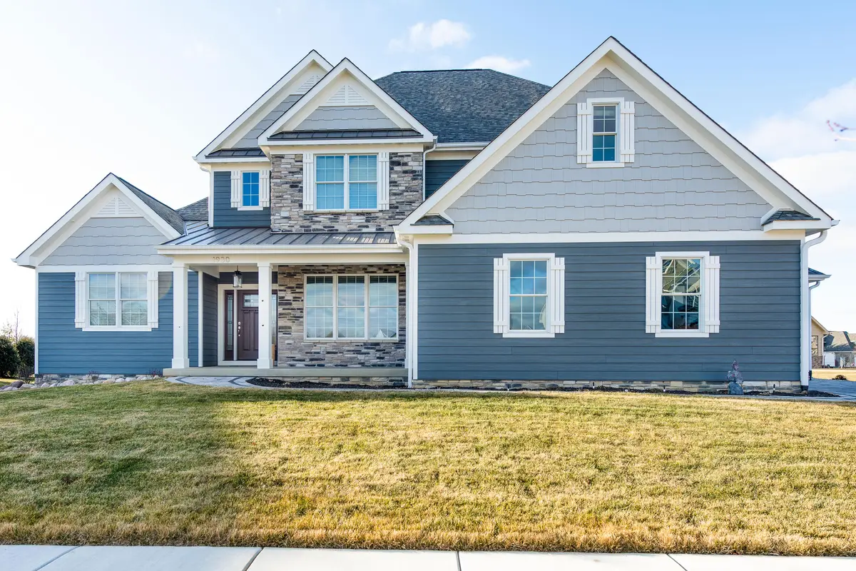 Two-story blue craftsman with stone accents