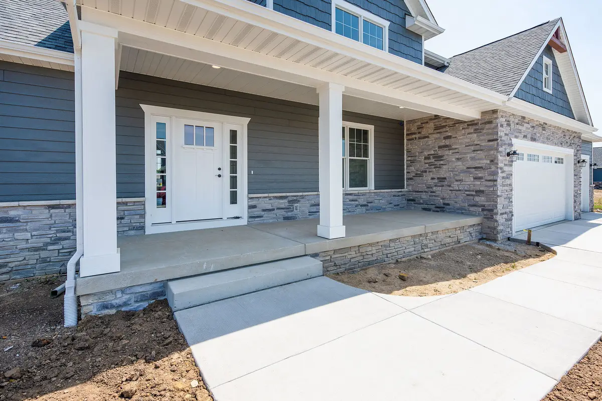 White craftsman home with covered entry