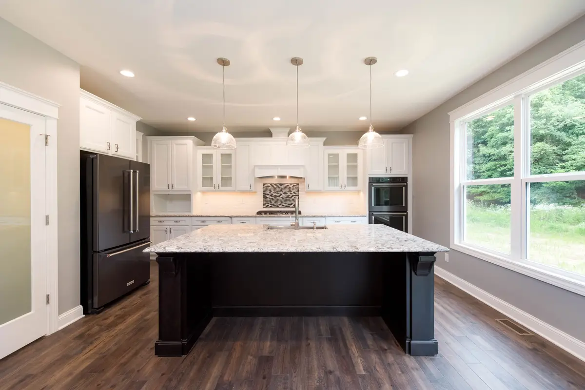 Two-tone kitchen with vaulted wood ceiling