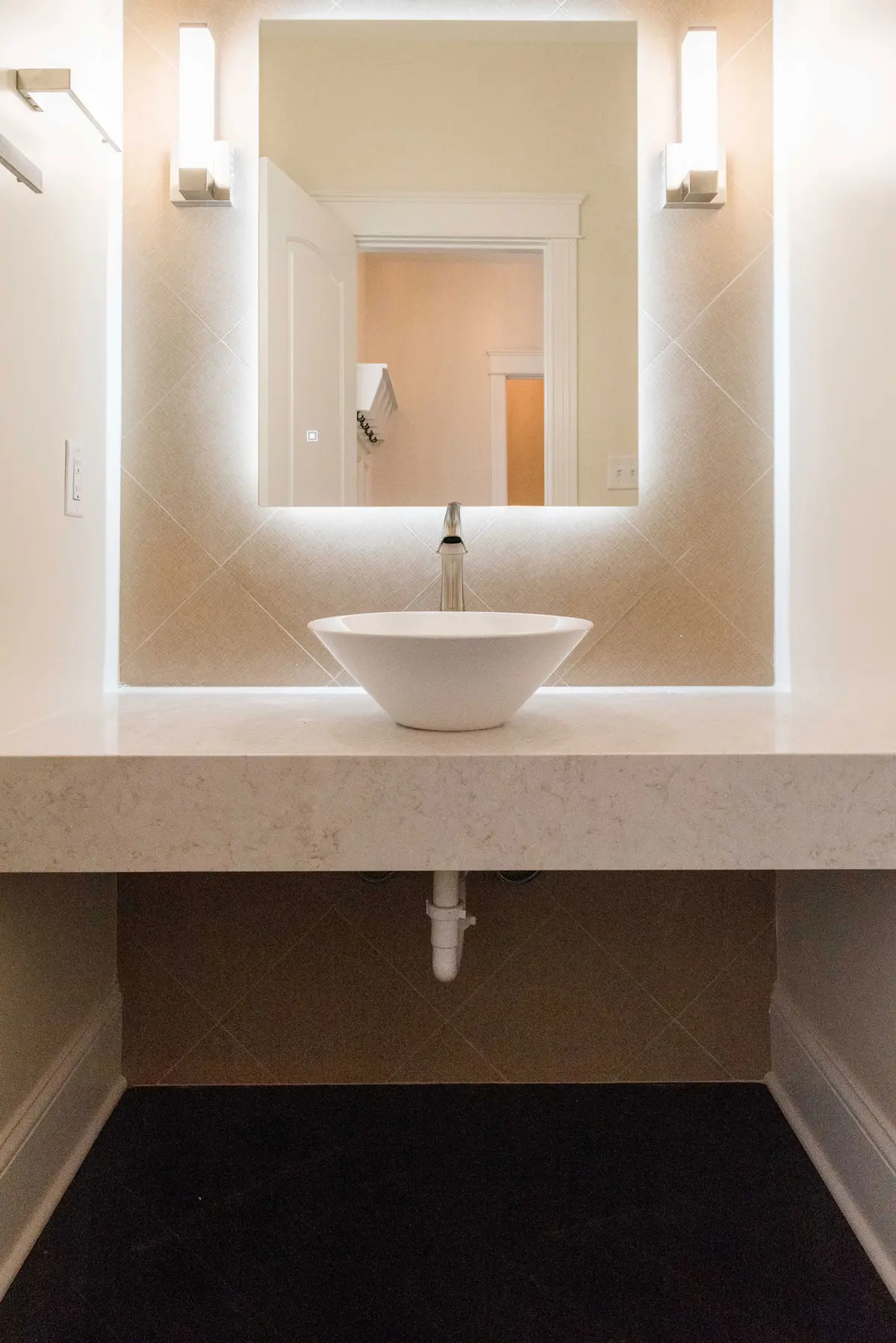 Vessel sink on a backlit floating vanity