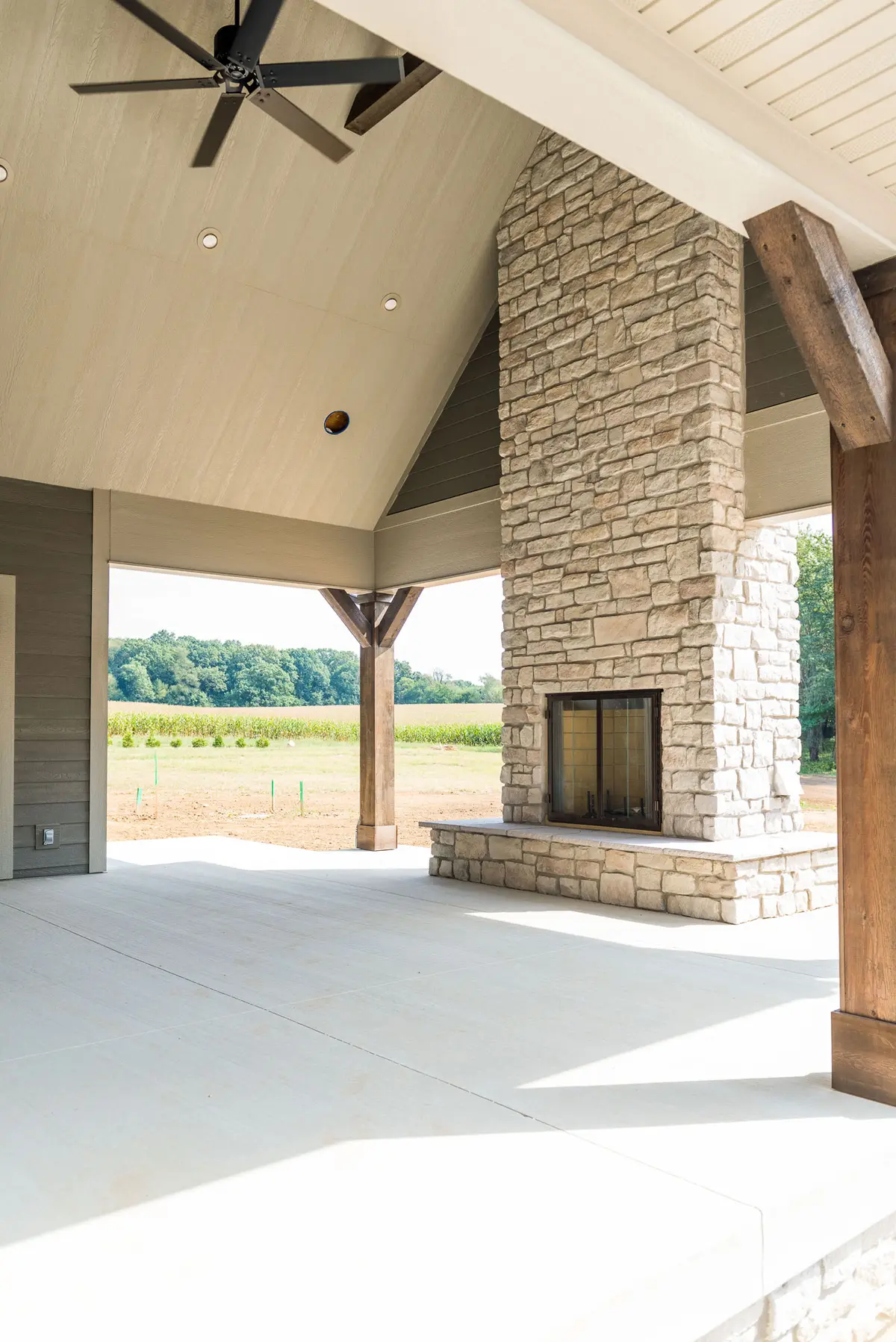 Outdoor stone fireplace under timber pavilion