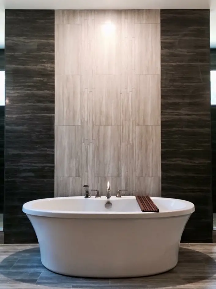 Freestanding tub centered on a floor-to-ceiling tile accent wall